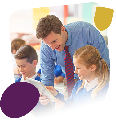 Male teacher in class with boy and girl pupil